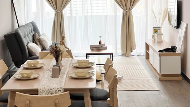 A modern living room with a sofa, dining table, and a TV on a stand. - MH Maison by Manhattan Group  (Kuala Lumpur)