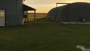 A rural barn with a covered area and a silo. - UNIQUE Grainbin Ranch Stay (Johnson City)