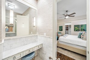 A bedroom with a bed, a ceiling fan, and artwork on the wall. - 5BR WaterColor Retreat: Beach Club Passes, Bikes, Electric Cart, Carriage House, Outdoor fireplace! (Santa Rosa Beach)