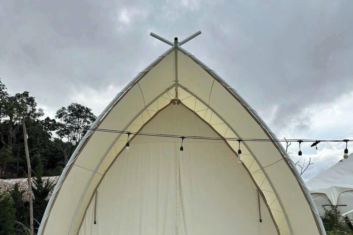 A tent with a peaked roof and a flat entrance platform.