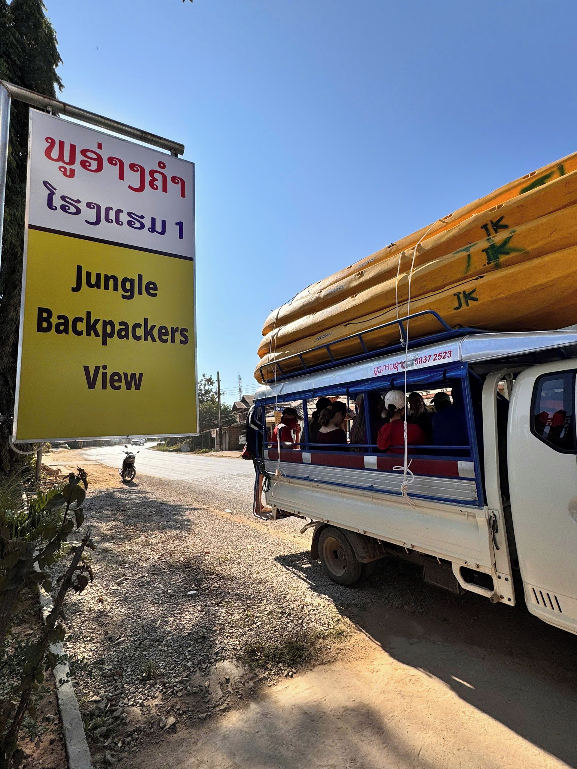 A bus with a Jungle Backpackers View sign, indicating a tour service.
