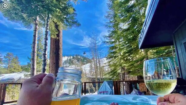 A hot tub with a clear view of a mountainous landscape and tall trees in the background. - ★★Ski In-Out! Mid-Mountain PALISADES home! Hot tub! Views! Walk to village! ★★ (Olympic Valley)