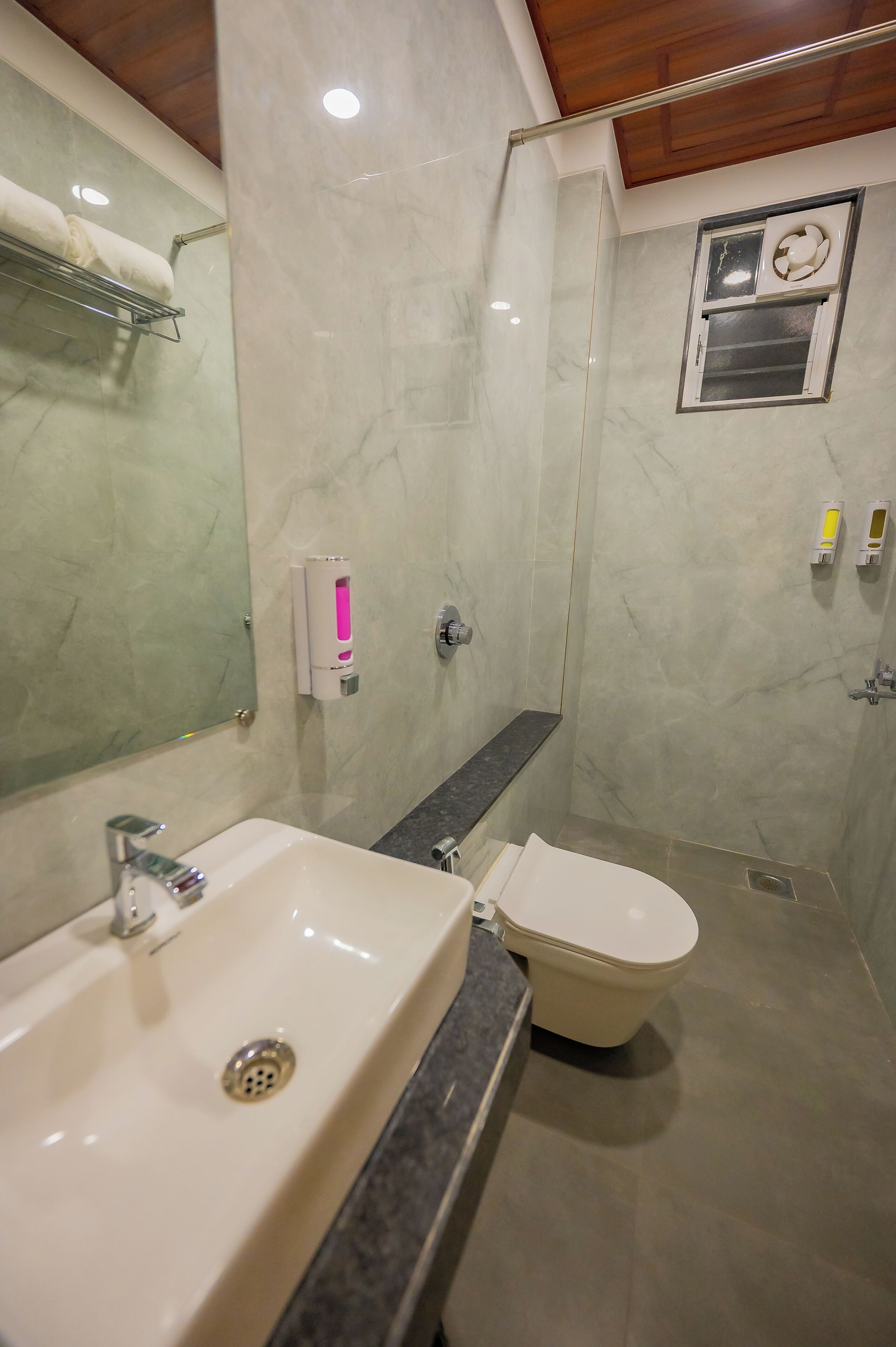 A bathroom with a sink, toilet, and shower.