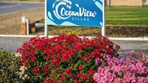 A sign for OceanView Villas with a clear view of the surrounding landscape. - Oceanview Villas (Mahomets Flats)