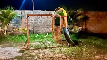 Kids can play on the swing set and slide in this outdoor play area.
