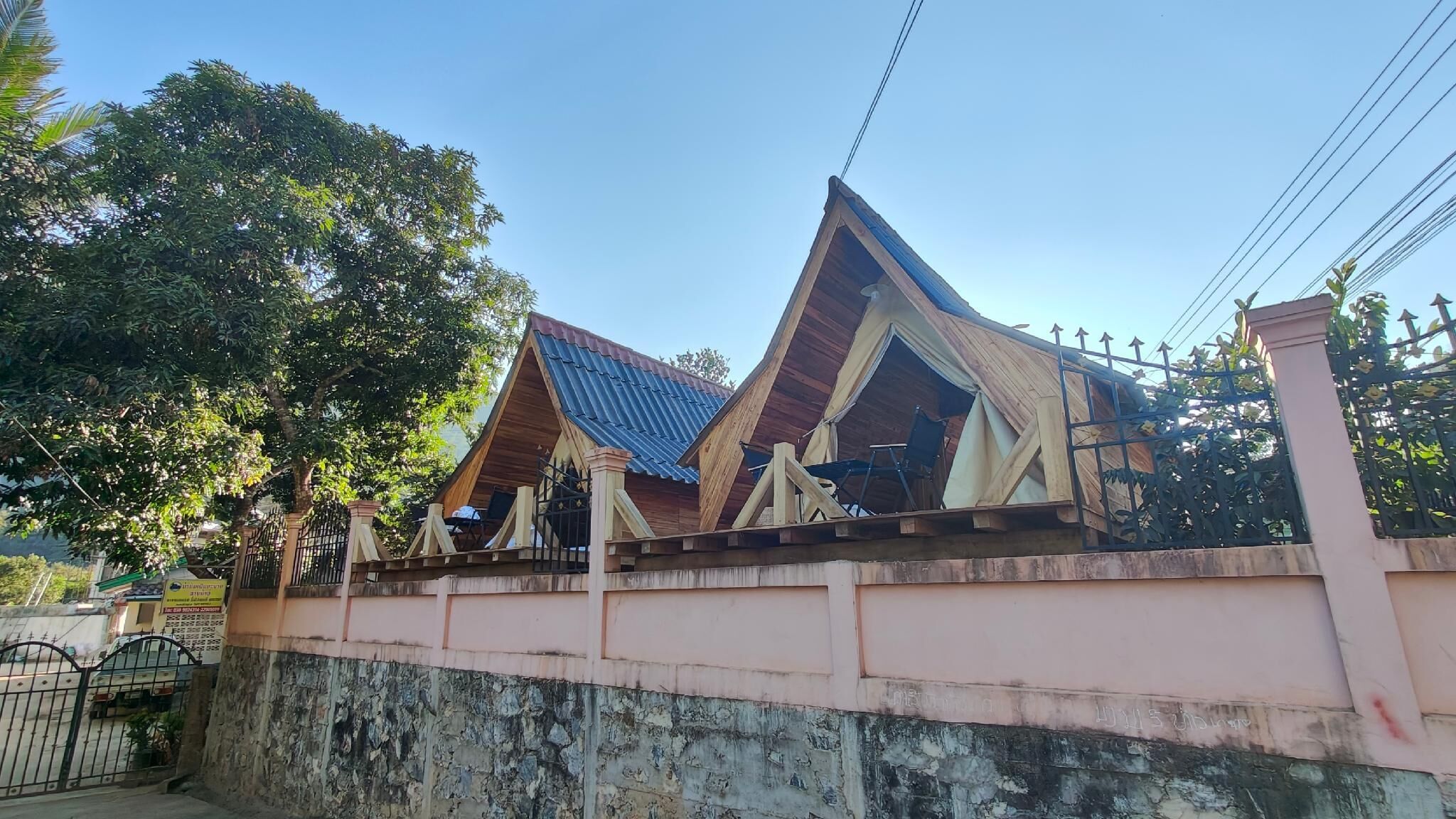 A traditional building with a sloped roof and a gated entrance.