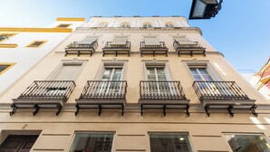 Un edificio con varios balcones y ventanas, que presenta un estilo arquitectónico clásico.