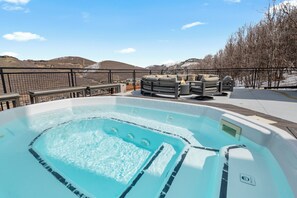 Ein Whirlpool mit Bergblick, eine umzäunte Terrasse und Sitzmöglichkeiten im Freien.