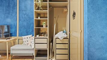 A room with a bed, a desk, a wardrobe, and a TV.