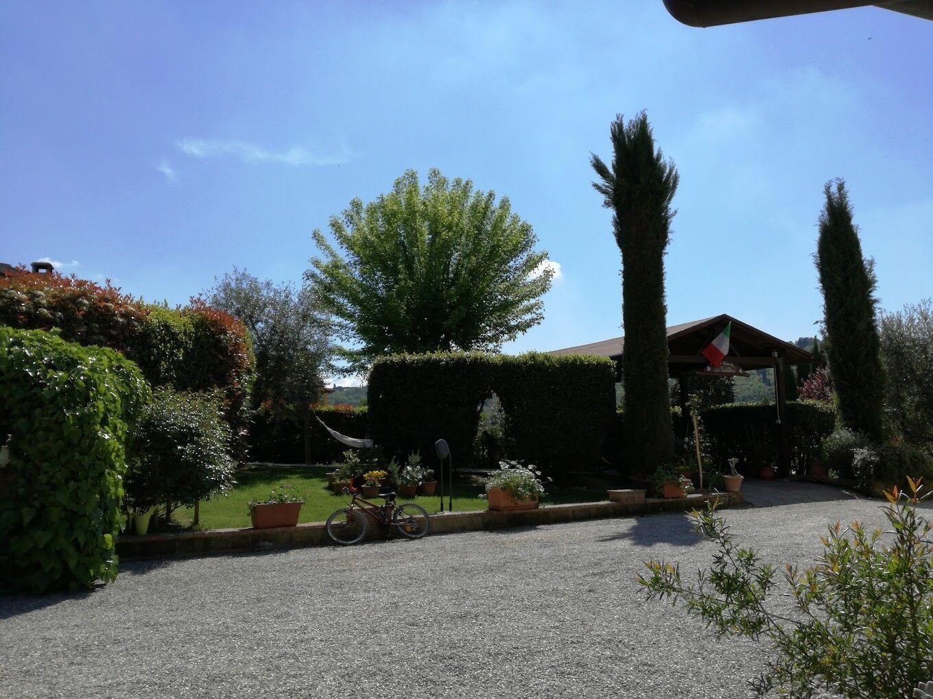 A well-maintained garden with various plants and a bicycle parked in the foreground.