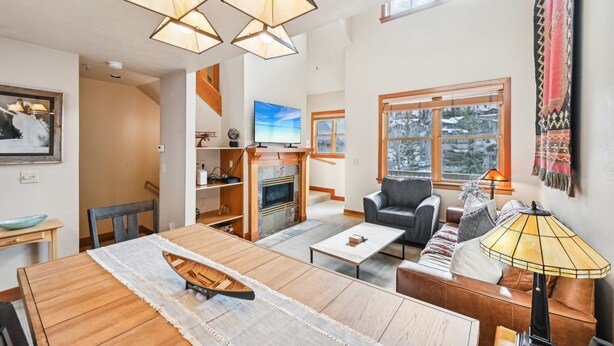 A spacious living room with a fireplace, a dining area, and a cozy seating area with a sofa and armchairs. - Park City in Prime Location/Sleeps 7/Summer AC (Park City)