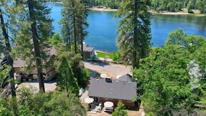 A house with a view of a lake, surrounded by trees.