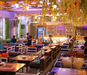 A modern bar area with seating and a bar counter. - The T Hotels (Pune)
