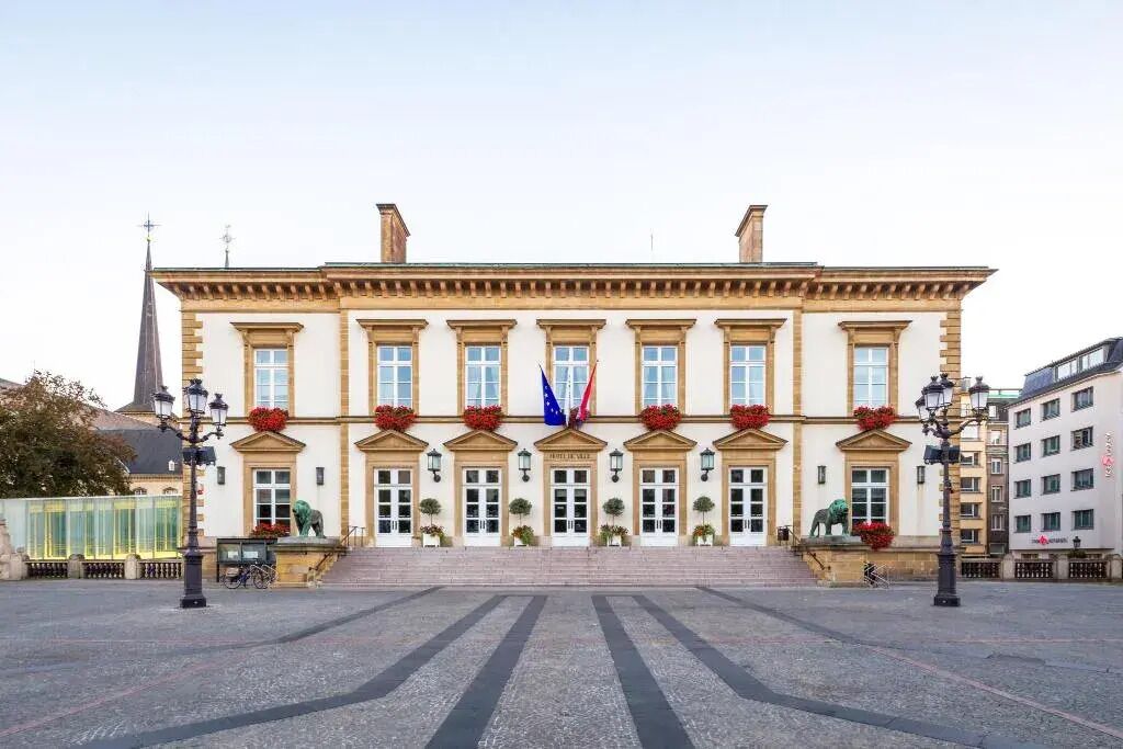 A historic building with a symmetrical facade, large windows, and a central entrance.