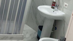 A bathroom with a shower, sink, and toilet. - Guazzo Home b&b Rione Sanità  (Napoli)