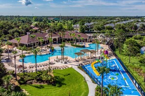A resort with a large swimming pool, a water slide, and multiple lounge areas. - 3 Mi to Disney: Family-friendly Home! (Kissimmee)