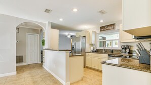 A modern kitchen with a central island, built-in appliances, and a welcoming sign. - 4 Mi to Lakes Park: Family Home in Fort Myers! (Fort Myers)