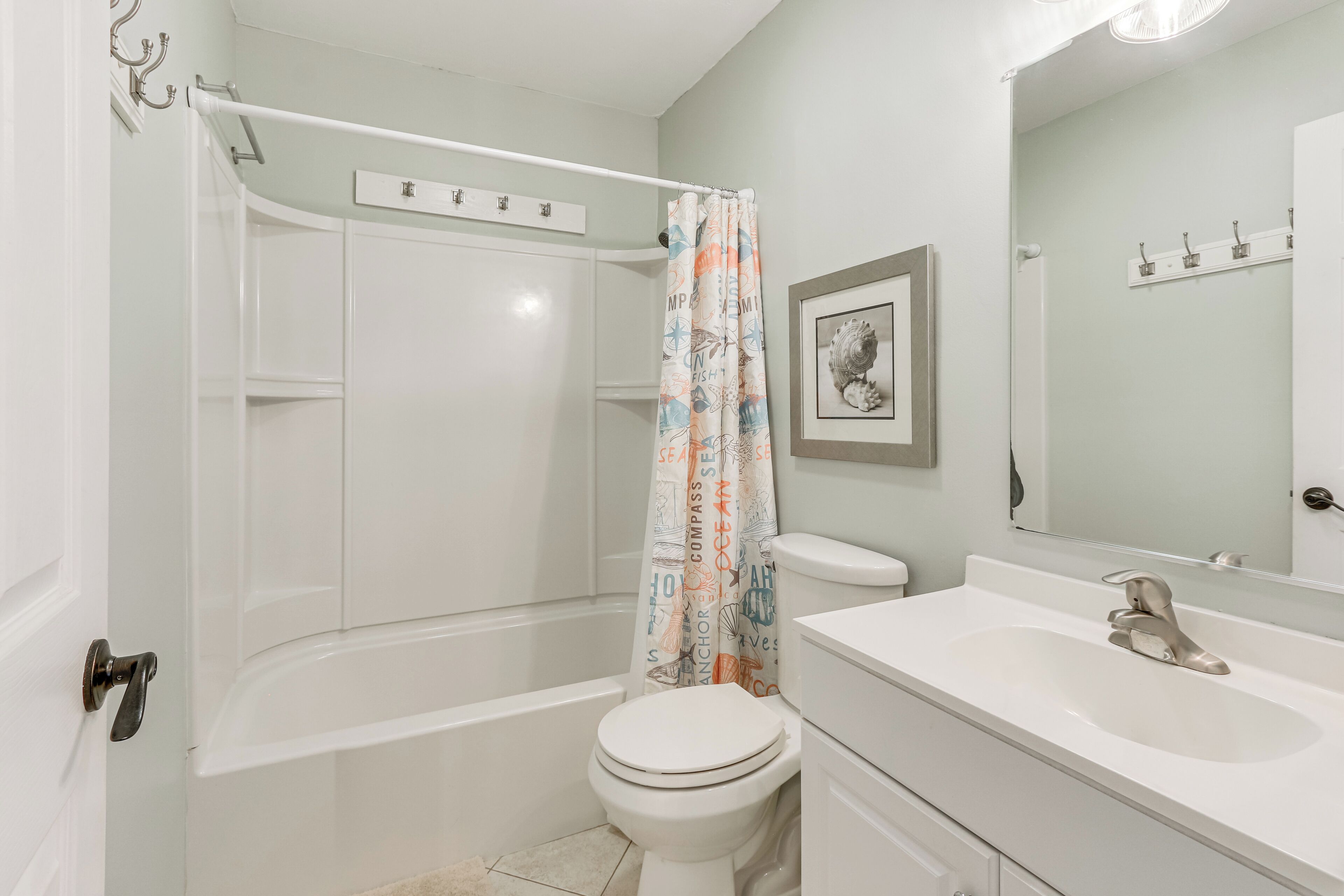 A bathroom with a bathtub, toilet, and sink.