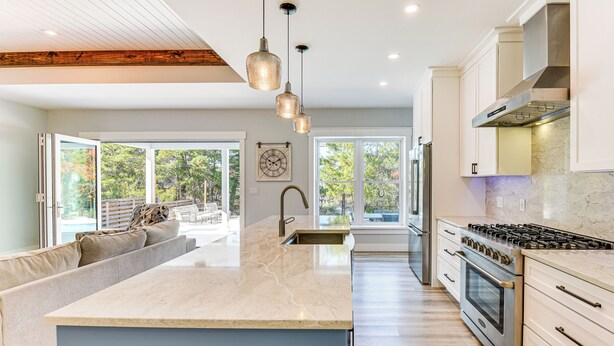 A modern kitchen with a large island, stainless steel appliances, and a view to the outdoors. - Tranquility & Nearby Beach Access: Private Oasis (Santa Rosa Beach)