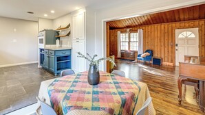 A spacious living area with a wooden ceiling, a dining table with a floral tablecloth, and a piano. - 4 Mi to Dtwn: Home w/ Fire Pit in Greenville (Greenville)