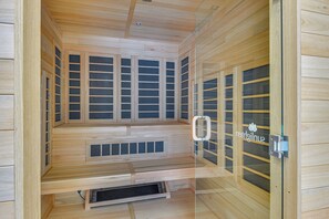 A sauna with wooden walls and multiple sliding glass doors. - Walk to Mount Snow Resort: Unit w/ Pool & Hot Tubs (West Dover)