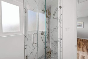 Shower, hair dryer, towels, shampoo