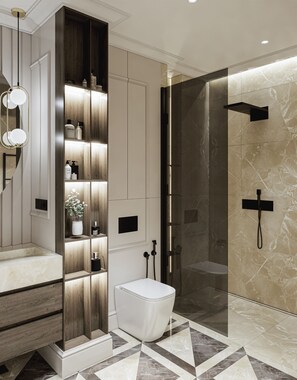 Enjoy a luxurious bathroom experience with a sleek vanity, shelving, and a glass-enclosed shower.