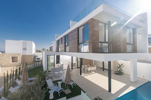 A modern two-story house with a swimming pool, outdoor seating, and a well-maintained garden. - Protaras Aqua Pearl Villa (Paralimni)