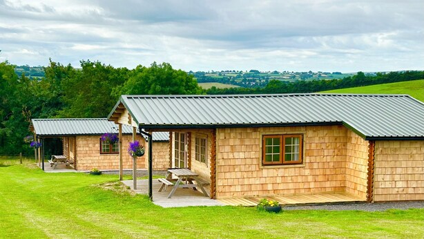 A wooden cabin with a metal roof, a picnic table, and a view of the countryside. - Moor View (Oak Tree Lane)
Gorgeous rustic charm (Okehampton)