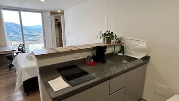 Fridge, microwave, coffee/tea maker, cookware/dishes/utensils