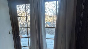 A room with a door leading outside, a doormat, and a pair of slippers on the floor. - Pet friendly 1 bedroom, in the heart of Snowmass Vlg (Snowmass Village)