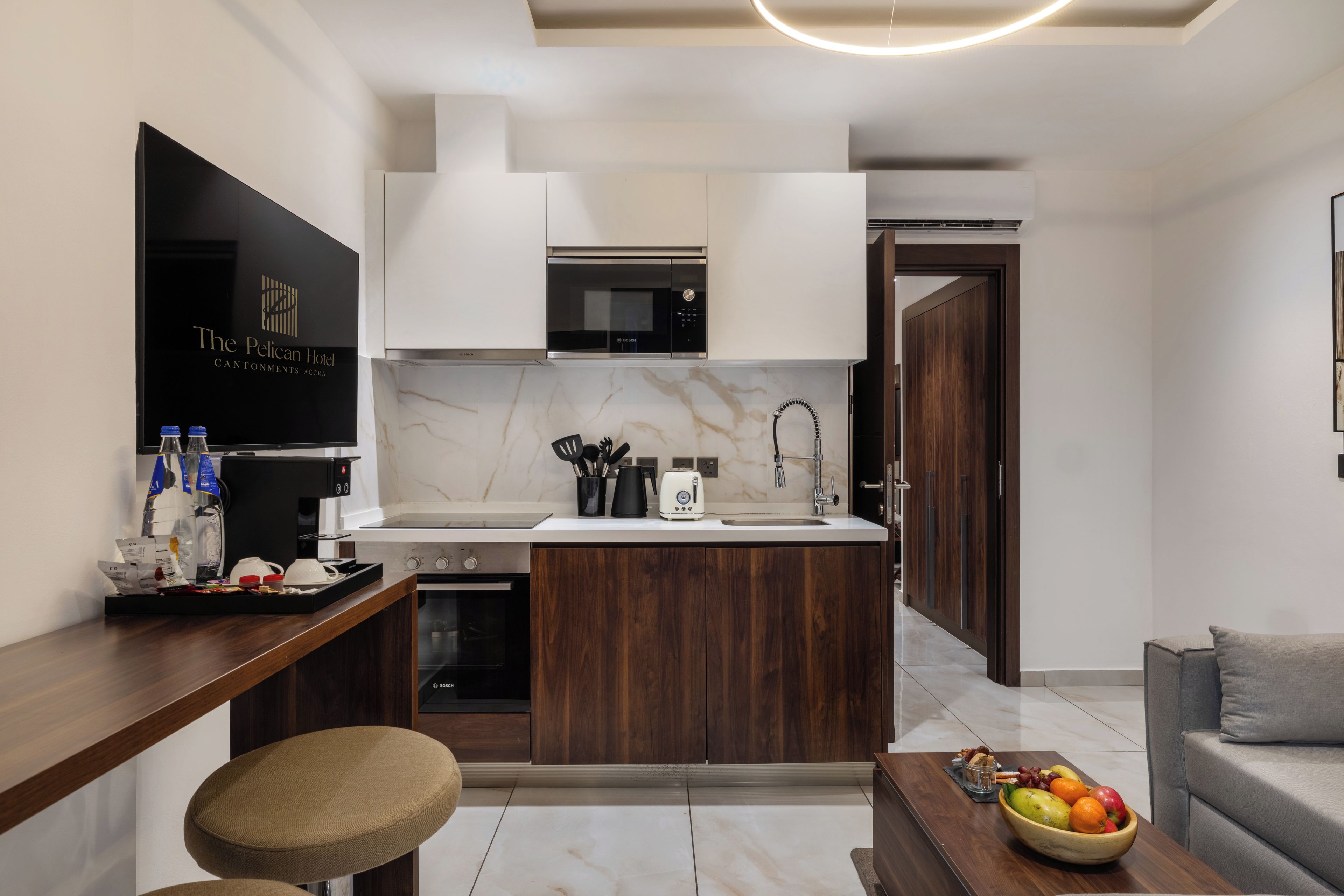 A modern kitchen with a Bosch microwave, a sink, and a coffee machine.