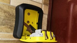 A yellow intercom system mounted on a wall with a brown door nearby. - Cozy 2-bedroom apartment in enjoyable Agadir with WiFi (Agadir)