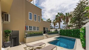 A modern outdoor pool area with lounge chairs, a hot tub, and a staircase leading to an upper level. - Bal One bedroom apartment Adults Only (203) (Arona)