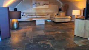 A modern living room with a sectional sofa, a coffee table, a lamp, and a painting on the wall. - Villa with pool in the heart of Provence, Pets welcome (Montfort)