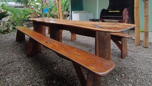 An outdoor dining area with wooden benches and tables, a grill, and a 'No Smoking' sign. - Caribbeans beach Cahuita (Beach house.) Near beaches, Houses in lemon. (Cahuita)