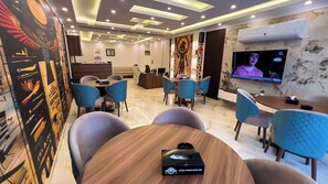 Relax in a stylish room with a central seating area, flat-screen TV, and Egyptian-inspired artwork.