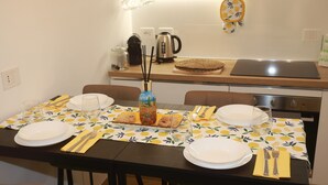 A dining table set with plates, cutlery, and a centerpiece. - Comfortable apartment in the center of Arenzano, a few steps from the sea (Arenzano)