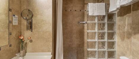 A bathroom with a shower, toilet, and sink.