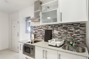 Fridge, microwave, stovetop, coffee/tea maker