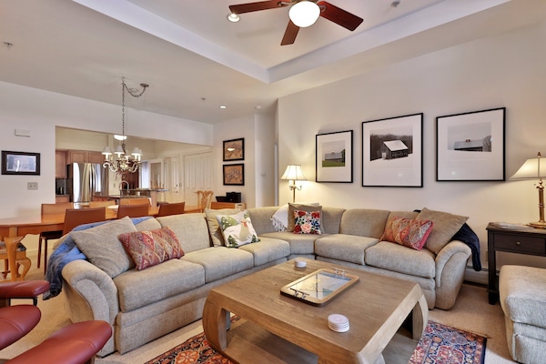 Enjoy a spacious living area with a large dining table, cozy sofas and a gas fireplace.