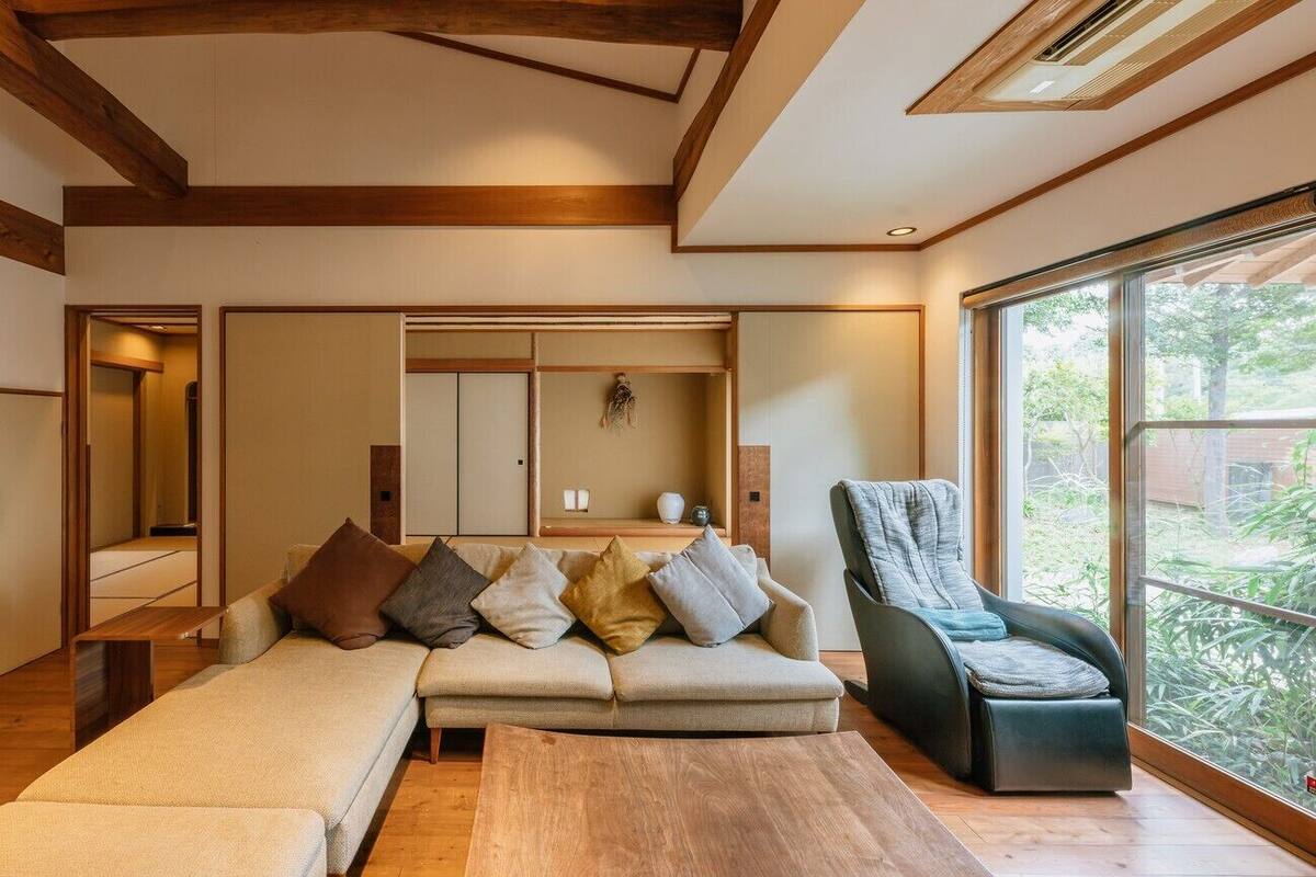A modern living room with a sofa, a chair, and a wooden coffee table.