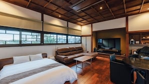 A bedroom with a bed, a sofa, a TV, and a desk. - Fukahoritei (Kurume)