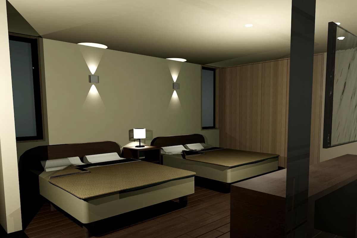 A hotel room with two beds, bedside tables, a desk, and a large mirror.