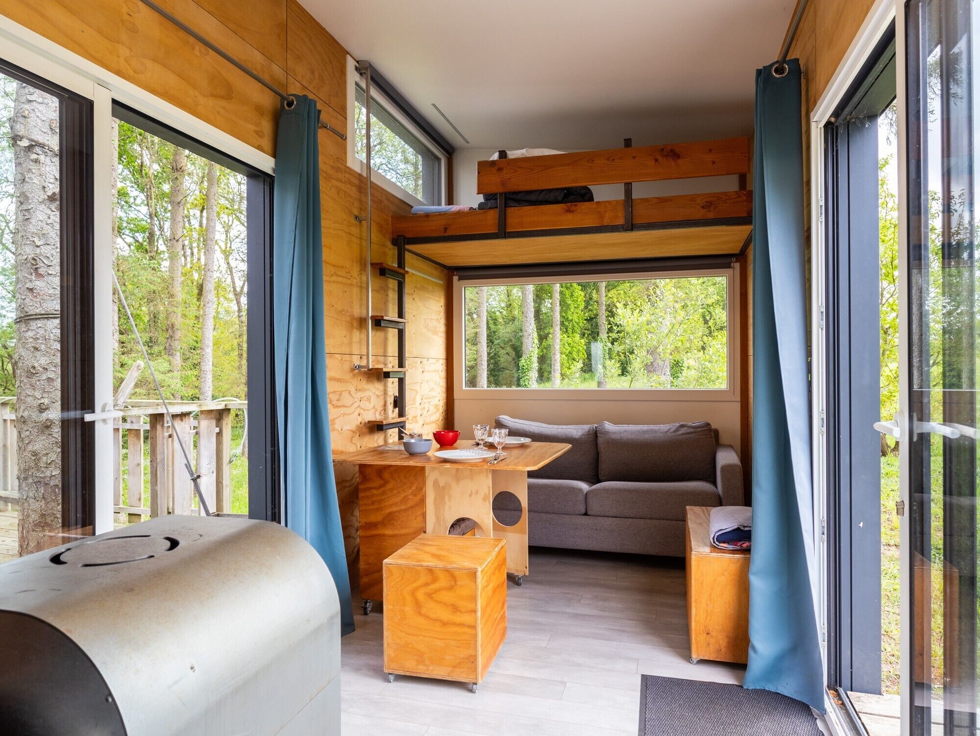 A compact living space with a kitchenette, a sofa, and a dining table.