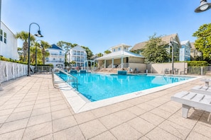 A swimming pool with a tiled deck, lounge chairs, and a covered seating area. - ☀️ New Rental, 6 Seat Golf Cart, Off 30A, 3 Min to Beach, Comm Pool, Foosball ☀️ (Santa Rosa Beach)