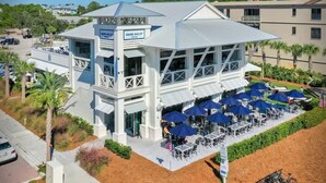 A beachfront bar with outdoor seating and a covered patio area. - Golf Cart ☀️ 6 Seat Cart thru 10/31, 3 Min to Beach, Foosball, Pool ☀️ Dune Allen (Santa Rosa Beach)