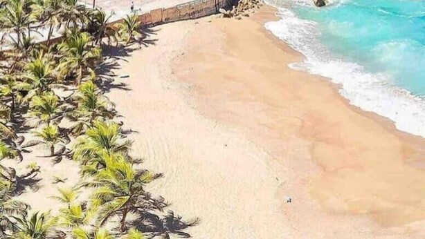 A beach with a tunnel entrance, clear blue water, and lush greenery. - Spacious and Modern Beach House With Pool (Hatillo)