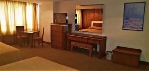 A hotel room with a bed, a desk, a chair, a television, and a painting on the wall. - Hotel Finisterre  (Mexico City)