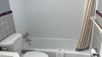 Combined shower/bathtub, towels, soap, toilet paper